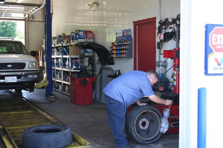 Mechanic Fixing the Tire of the Car